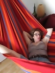 streching her legs in the hammock